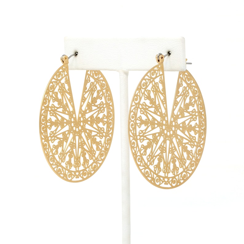 A pair of lightweight filigree statement hoop earrings in gold.