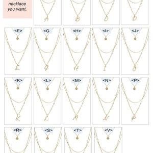 Puede incluir: Una selecci&oacute;n de collares de oro en capas con un solo dije inicial en cada uno. Las letras son A, B, C, D, E, G, H, I, J, K, L, M, N, P, R, S, T y V.