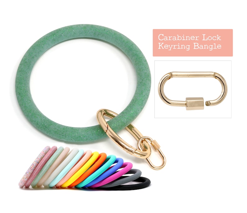 May include: Green glitter silicone bangle with a gold carabiner lock. The bangle is a keychain and can be worn as a bracelet.  Carabiner Lock Keyring Bangle.