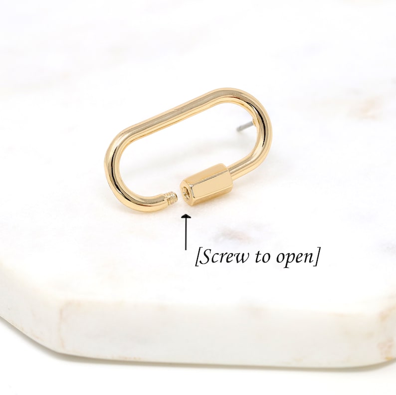 May include: Gold-toned metal lobster clasp with a screw closure. The clasp is open and the screw is visible. [Screw to open]