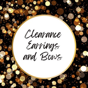 May include: A white circle with a gold border on a black background with gold glitter. The text inside the circle reads "Clearance Earrings and Bows".