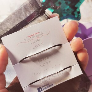 May include: Two black string bracelets with silver beads spelling out "LOVE" in Morse code. The bracelets are on a white card with the text "Together forever The Morse code For Her LOVE For Him LOVE Kathryn's Bracelets Find us on Facebook Kato Jewelry".