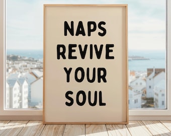 May include: A framed print with the text "NAPS REVIVE YOUR SOUL" in black bold letters on a cream background.