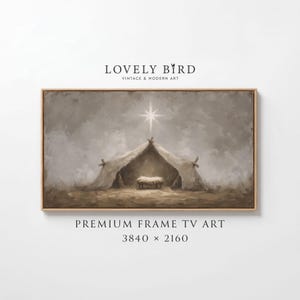 Peut inclure: Une œuvre d'art encadrée représentant une scène de la Nativité avec une étoile au-dessus d'une structure en forme de tente. La peinture utilise des tons sourds de brun, beige et blanc. Le texte "LOVELY BIRD VINTAGE & MODERN ART" et "PREMIUM FRAME TV ART" sont visibles.