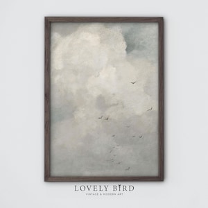 May include: A framed watercolor painting of a cloudy sky with a flock of birds flying in formation. The sky is a soft gray and white, with hints of blue. The birds are black silhouettes against the clouds.