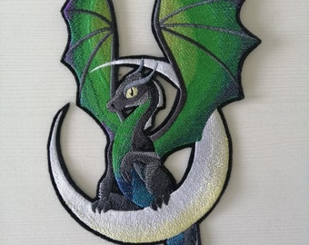 May include: An embroidered iron-on patch featuring a green, black, and purple dragon curled around a white crescent moon.