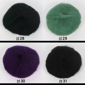 May include: Four balls of yarn in different colors: black, green, purple, and black. The yarn is soft and fluffy, and it is perfect for knitting or crocheting.