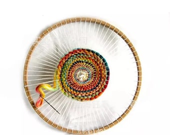 May include: A circular wooden loom with a colourful woven tapestry in the centre. The tapestry is made with a variety of coloured yarns and has a spiral pattern. A needle and yarn are visible in the loom.