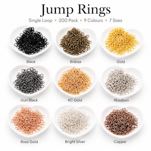 May include: A collection of jump rings in nine colours including black, bronze, gold, gun black, KC gold, rhodium, rose gold, bright silver, and copper. Each colour is displayed in a heart-shaped dish. Text reads Jump Rings, 200 Pack, 9 Colours, 7 Sizes.