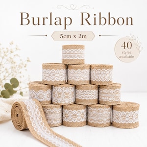 May include: A collection of tan burlap ribbon rolls, each featuring a white lace trim. The text Burlap Ribbon, 5cm x 2m, and 40 styles available is printed above the stacked rolls. The rolls are arranged in a pyramid formation on a surface.