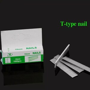 May include: A box of 10mm T-type nails with the word "NAILS" printed on the box. The box is white with green accents and contains 1000 pieces. Several nails are displayed next to the box.