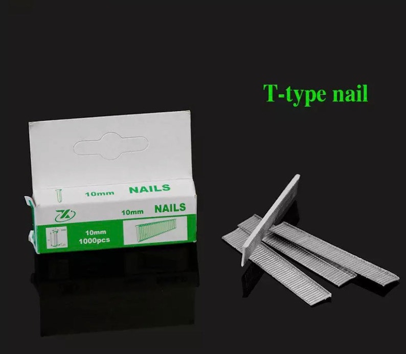 May include: A box of 10mm T-type nails with the word "NAILS" printed on the box. The box is white with green accents and contains 1000 pieces. Several nails are displayed next to the box.
