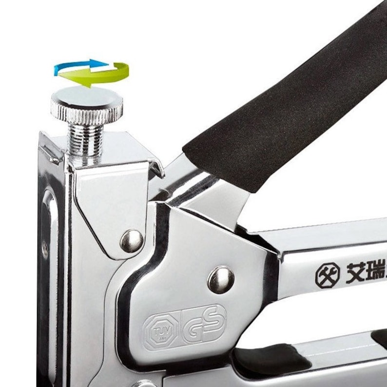 May include: Close-up of a chrome-plated staple gun with a black handle. The gun features a silver adjustment knob and a black grip. The image shows a detail of the tool's mechanism and design.