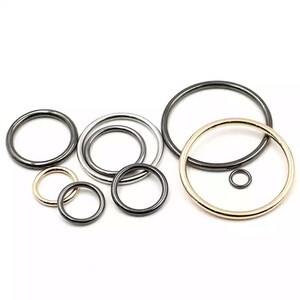 May include: Assortment of metal rings in different sizes and finishes, including gold, silver, and black. The rings are perfect for crafting, jewelry making, and other DIY projects.