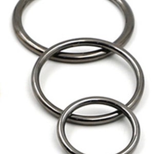 May include: Three silver metal rings of different sizes, stacked on top of each other.