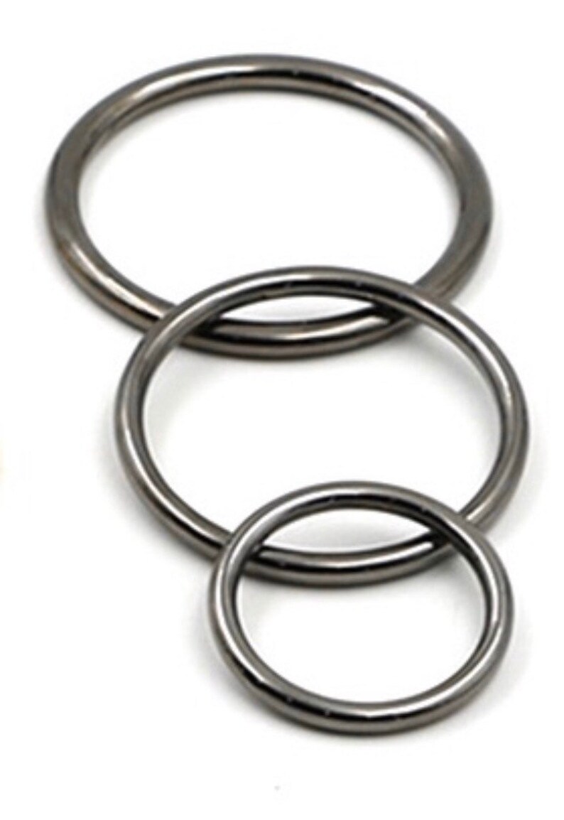 May include: Three silver metal rings of different sizes, stacked on top of each other.