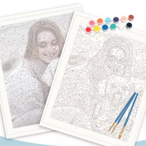 May include: Two paint-by-number canvases featuring outlines of a person and a dog, accompanied by a set of small circular paint pots in various colors and two blue-handled paintbrushes with gold-toned metal ferrules and light-colored bristles.