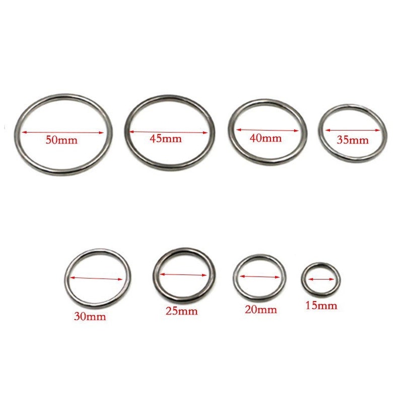 May include: Set of 8 silver metal rings in various sizes, ranging from 15mm to 50mm in diameter. The rings are smooth and have a polished finish.