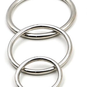May include: Three silver metal rings of different sizes, nested together.