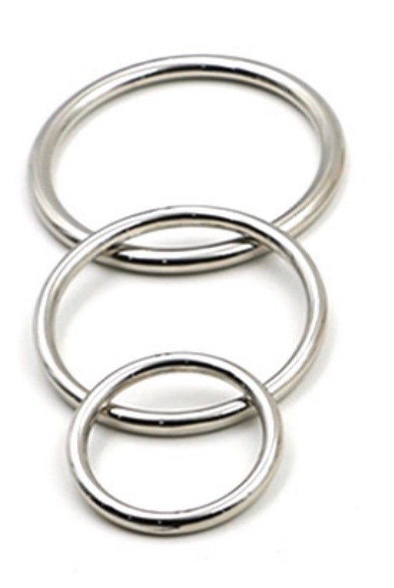 May include: Three silver metal rings of different sizes, nested together.