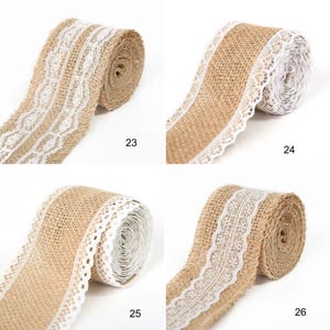 May include: Four rolls of tan burlap ribbon, each featuring a distinct white lace trim pattern along the edges. The rolls are labeled with the numbers 23, 24, 25, and 26, showcasing various intricate woven designs on the textured brown fabric.