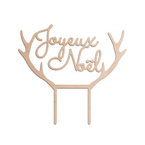 Peut inclure: Décor de gâteau en bois avec des bois de renne et le texte "Joyeux Noël" en écriture cursive.