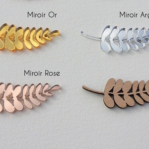Puede incluir: Cuatro formas de ramas de hojas en diferentes acabados: espejo dorado, espejo plateado, espejo dorado rosa y madera. El texto "Miroir Or", "Miroir Argent", "Miroir Rose" y "Bois" est&aacute; sobre cada rama.