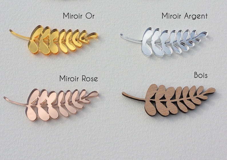 Puede incluir: Cuatro formas de ramas de hojas en diferentes acabados: espejo dorado, espejo plateado, espejo dorado rosa y madera. El texto "Miroir Or", "Miroir Argent", "Miroir Rose" y "Bois" est&aacute; sobre cada rama.