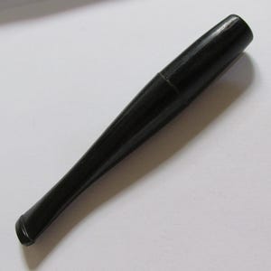 May include: A black, tapered cigarette holder. The holder is made of a smooth, solid material and has a slightly curved mouthpiece. The design is simple and elegant, with a classic aesthetic.