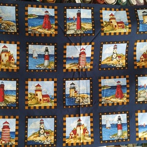 Patchwork fabric, 14 lighthouse pictures on two rows,