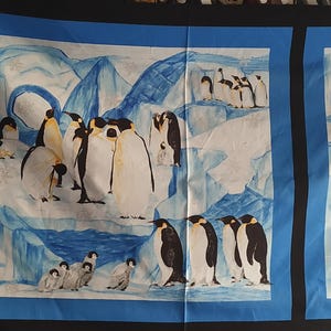 May include: A fabric panel with a watercolour painting of penguins in an icy landscape. The penguins are black, white, and yellow, set against a backdrop of blue ice formations and a blue border. The scene depicts various penguin groupings.