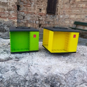 Pair of two cassette tape holders, yellow and green cassette tape holders