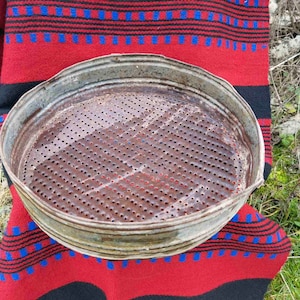 Primitive handmade sieve, old metal sieve