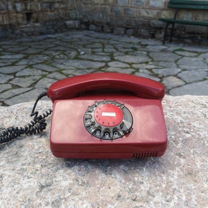 Vintage rotary Siemens phone, cherry red color vintage telephone