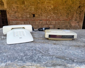 Ivory white telephone and a radio alarm clock, Vintage digital white telephone and a radio alarm table clock