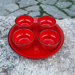 Red ceramic sauce bowls and a plater, vintage red pudding bowls