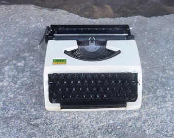 Brother 210 portable manual typewriter with original case and new ribbon, English alphabet