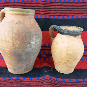 Two handmade pottery pitchers, antique rustic and primitive pitchers