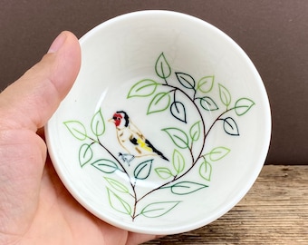 Small pottery porcelain bowl with goldfinch