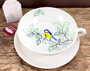 Pottery porcelain tea cup and saucer with blue tit