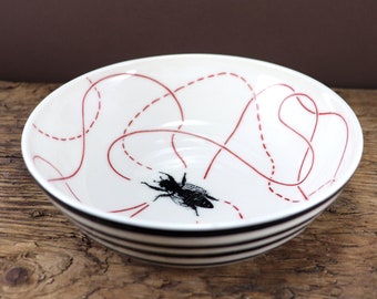 Shallow striped ceramic bowl with porcelain bee