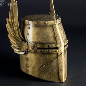 Gold Daubeny Winged Helmet inspired by the For Honor Knight game series, featuring an intricate winged design and realistic structure. Made from lightweight EVA foam, it looks like real metal. Crafted by a professional artisan prop maker.