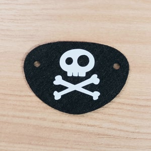 May include: Black felt pirate eye patch with a white skull and crossbones design.