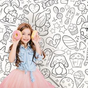 There is happy girl and coloring wallpaper for kids rooms with black outlines in doodle style in the background.
The product is a DIY wall art for coloring. Wallpaper design  showcases cartoon expressive faces characters, all radiating positive vibes