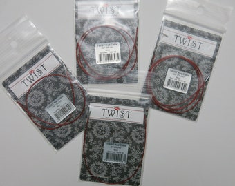 May include: Four packages of red Twist brand knitting cables. Each package contains a different length cable: 22", 29", 36", and 43".