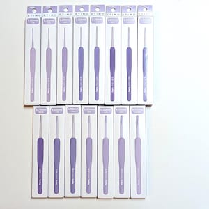 May include: A collection of fifteen Tulip Etimo crochet hooks in individual light purple and white retail packaging. Each box displays the specific hook size ranging from 1.80mm to 6.50mm, with the hook handle colour matching the packaging shade.