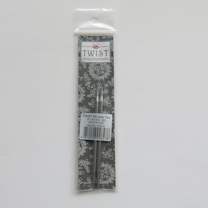May include: A package of two silver Twist 85 Lace Tips knitting needles, size 4 (3.5 mm). The package is gray with a white floral pattern and the brand name "Twist" in white.