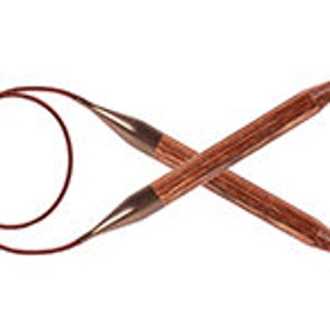 May include: A pair of wooden knitting needles with a red cord connecting the tips. The needles are crossed in an 'X' shape.