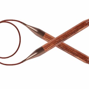 May include: A pair of brown wooden circular knitting needles with a brown cord connecting the two tips.