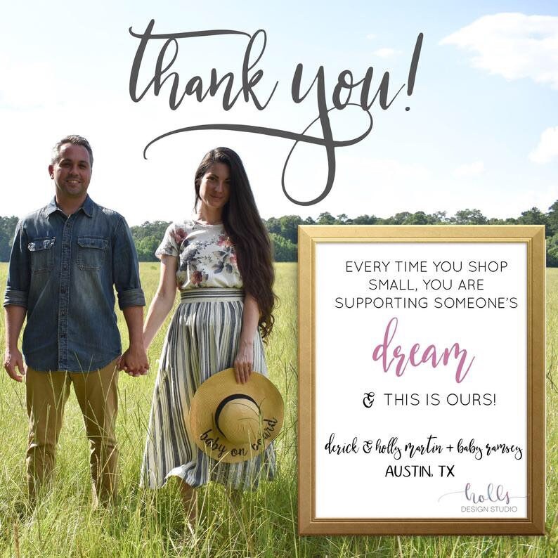 May include: A couple stands in a field holding hands. A sign reads "Every time you shop small, you are supporting someone's dream & this is ours!"  The sign also includes the text "derick & holly martin + baby ramsey AUSTIN, TX holls DESIGN STUDIO".